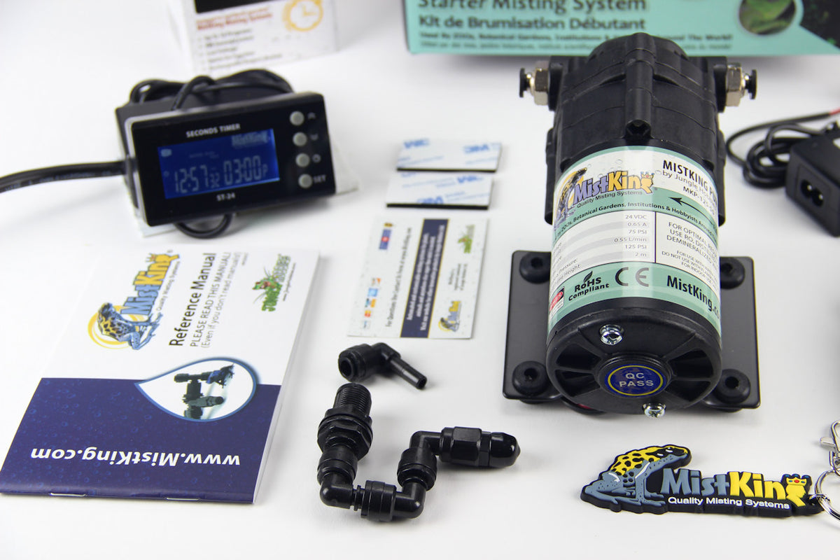 Closeup of L-joint, compressor, seconds timer, and more components for mistking system on a white background